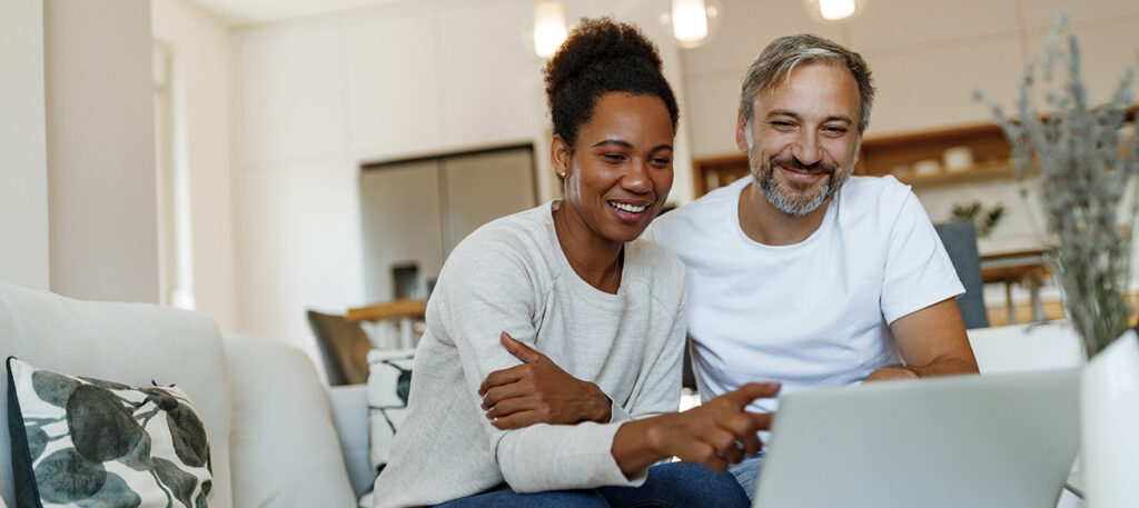 couple using laptop looking for legal representation; Broward County Estate Lawyer and Hendry County Estate Planning Lawyer concept image