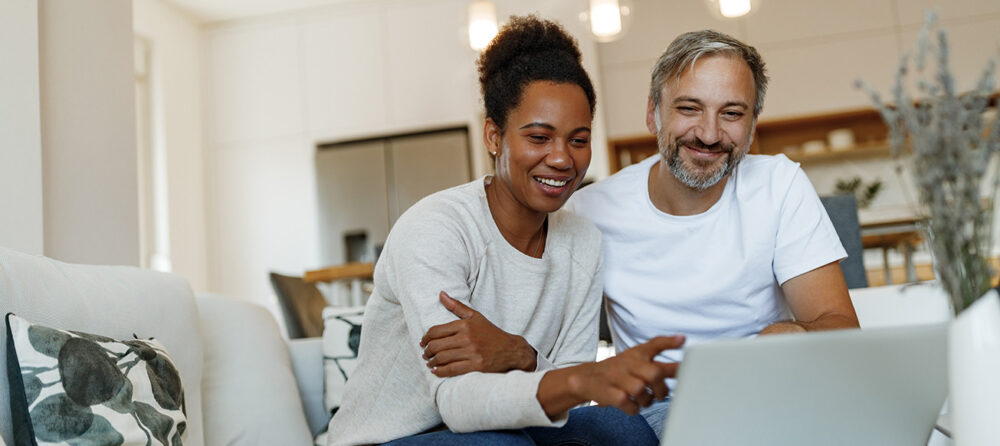 couple using laptop looking for legal representation; Broward County Estate Lawyer concept image