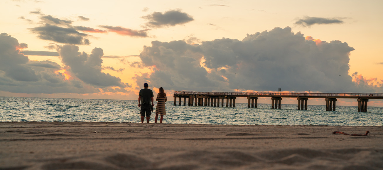 A couple on a florida beach at sunset; Florida Estate Lawyer concept image