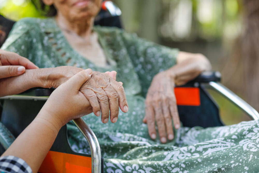 elder holding hand